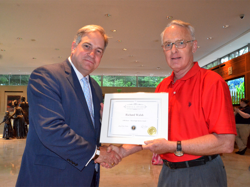 Richard Walsh receiving a volunteer service award from President and CEO Doug Bradburn
